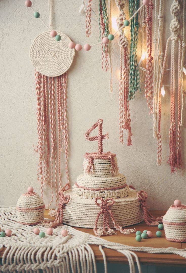 a table topped with lots of tassels next to a wall