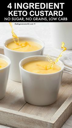 three white bowls filled with soup sitting on top of a wooden tray