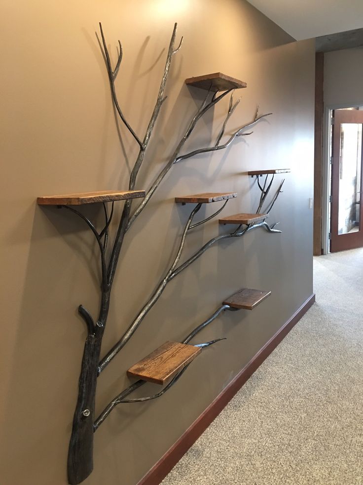 an empty hallway with metal branches on the wall