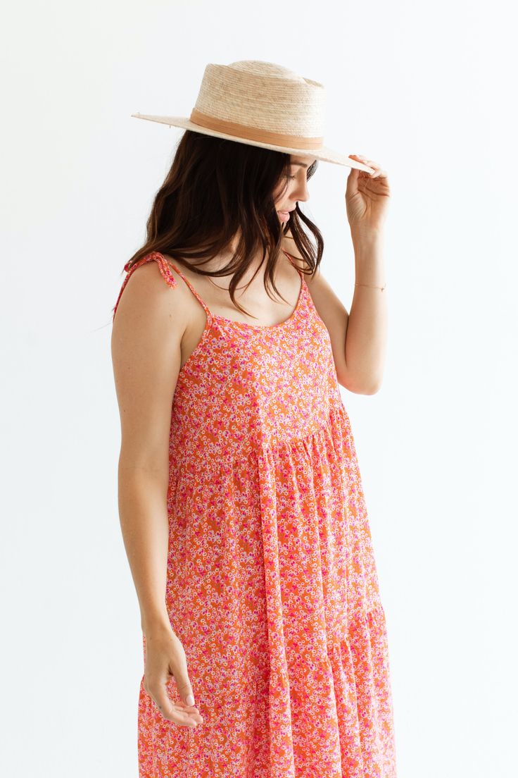 Due to production delays, any order with this item will ship the week of July 15th - July 29th Introducing the Millie Dress, in a fun new print that is super happy and reminds us of Kauai. With tie straps, a beautiful and vibrant pink floral, and a textured fabric, you'll feel elegant and relaxed all day long. The modest neckline and perfect length add the finishing touch to this playful and stylish dress. Bethany Hamilton x CJLA Collection FIT Made in LA Easy, Flowy Fit Adjustable Tie Straps Nursing Friendly Not Stretchy, Size Up for Larger Bust Bethany is 5'11 Wearing Size Large Bridget is 5'9 Wearing Size Small X-SMALL SMALL MEDIUM LARGE X-LARGE 50" Long 51" Long 52" Long 53" Long 54" Long 17" Wide 18" Wide 19" Wide 20" Wide 21" Wide For more sizing information, please click HERE MATERI Beach Sundress With Knotted Straps For Spring, Summer Patterned Spaghetti Strap Dresses, Pink Vacation Dress With Knotted Straps, Summer Sundress With Knotted Straps For Garden Party, Patterned Spaghetti Strap Dress For Spring, Patterned Spring Dresses With Spaghetti Straps, Casual Floral Sleeveless Dress With Adjustable Straps, Pink Mini Sundress With Adjustable Straps, Pink Beach Dress With Knotted Straps