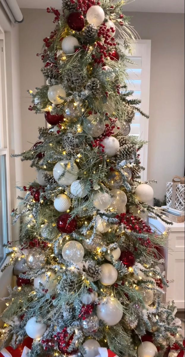 a decorated christmas tree with red and white ornaments