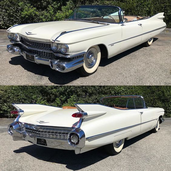 an old white car parked in a parking lot next to another classic car with the hood up