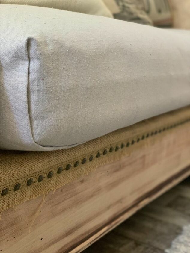 a close up view of a bed with pillows on it's headboard and foot board