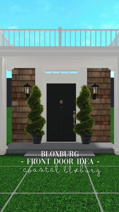 the front door of a house with two potted plants on either side of it