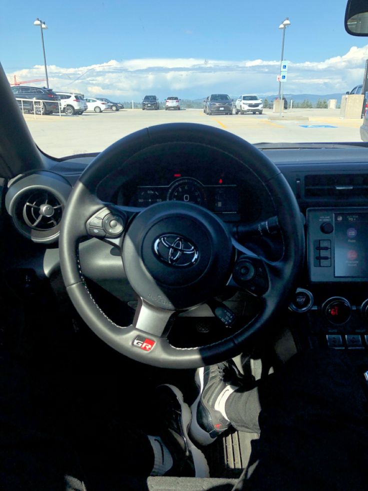 the interior of a car with steering wheel and dashboard