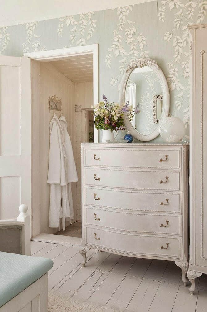 a white dresser and mirror in a room