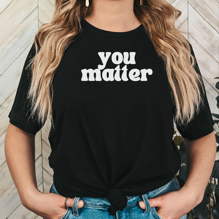 YOU MATTER Shirt with "You Matter" written on the front and back Unisex 100% cotton making shirt super soft, comfortable and lightweight. Runs true to size Machine wash inside out in cold water Questions?  Contact me, I want to hear from you. Concerns? Kindly reach out to me so I can make things right!  Thank You for choosing MADesigns! Inspirational Slogan Shirt, Inspirational Black Cotton Tops, Inspirational Black Pre-shrunk Top, Inspirational Black Tops With Text Print, Inspirational Text Print Black Tops, Be Kind Shirt, Show Love, Kindness Shirts, You Matter