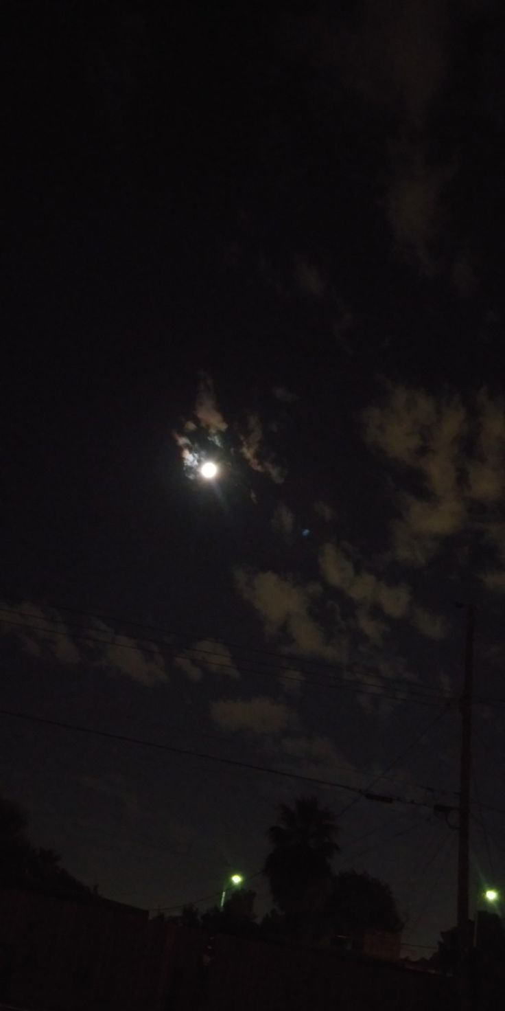 the moon is shining brightly in the night sky