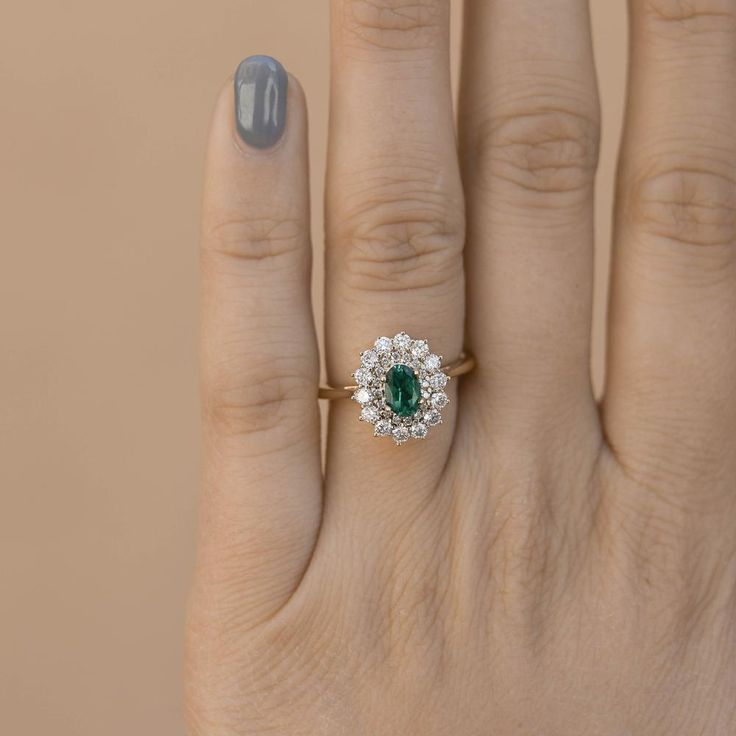 Oval Halo Ring With May Birthstone, Oval Halo Emerald Ring For May Birthstone, Classic Green Cluster Ring With Halo, Oval Emerald Cluster Ring With Halo Design, Oval Emerald Ring With Halo Design, Heirloom Green Oval Halo Ring, Classic Oval Green Halo Ring, Heirloom Style Oval Emerald Ring With Halo Design, Heirloom Oval Emerald Ring With Halo Design