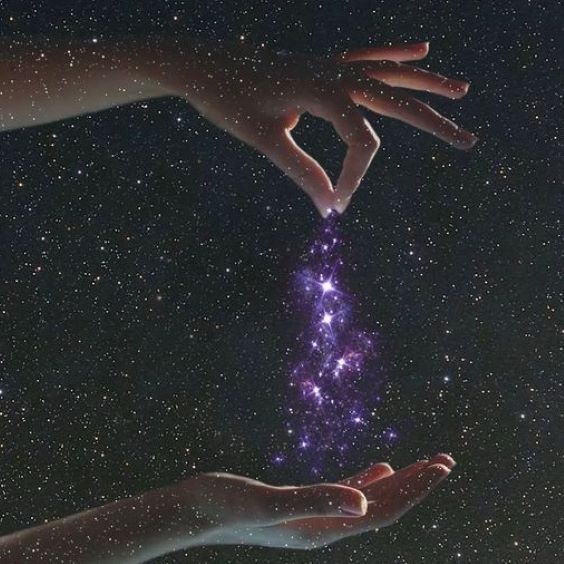 two hands reaching for the stars in the sky