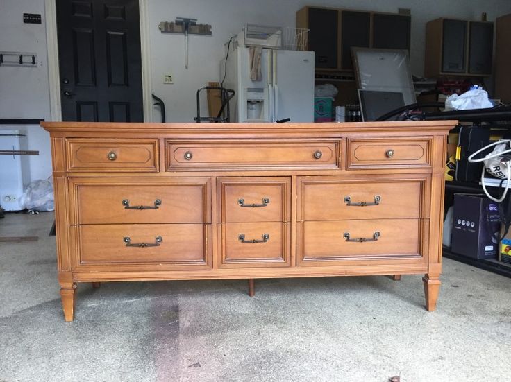 a large wooden dresser sitting inside of a garage