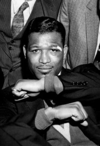 a black and white photo of two men in suits