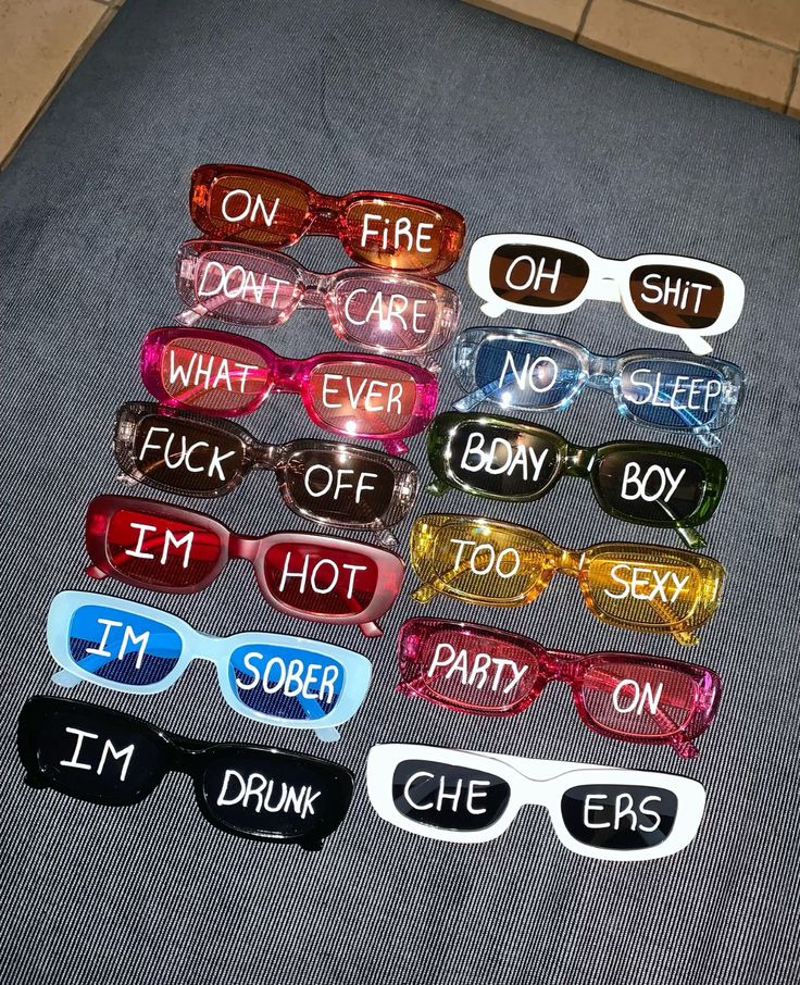 six pairs of glasses with words on them sitting on the floor next to each other