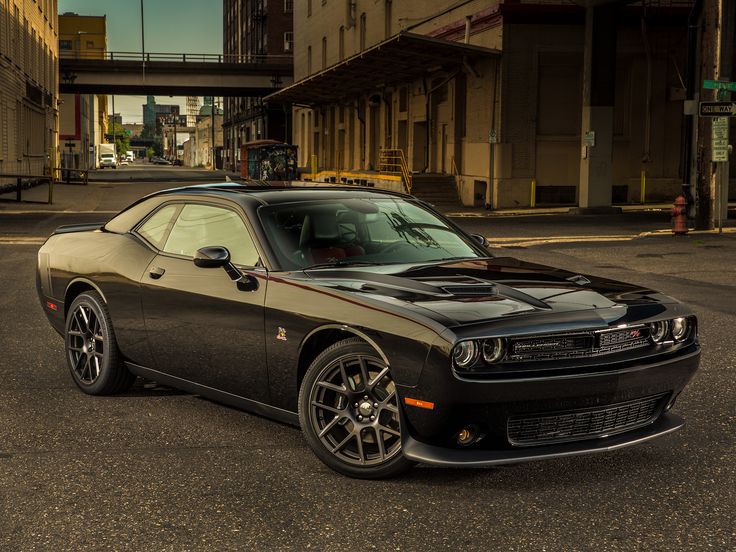 a black car is parked on the street