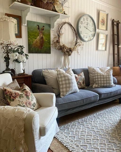 a living room filled with furniture and lots of pillows on top of it's couches