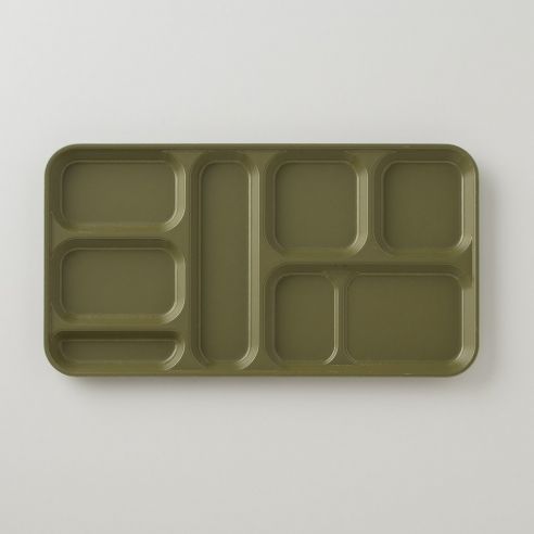 an empty green tray with compartments on it