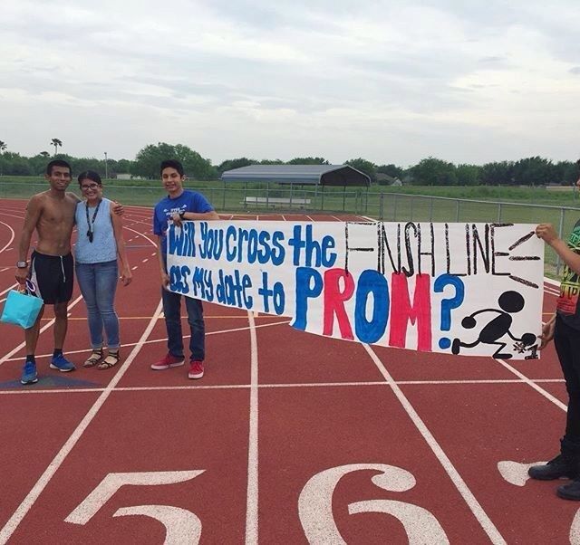 some people standing on a track with a sign