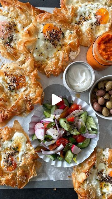 several different types of food sitting on a table with dipping sauces and dip bowls