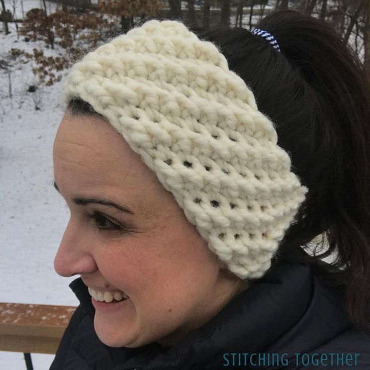 a woman wearing a white knitted headband in the snow