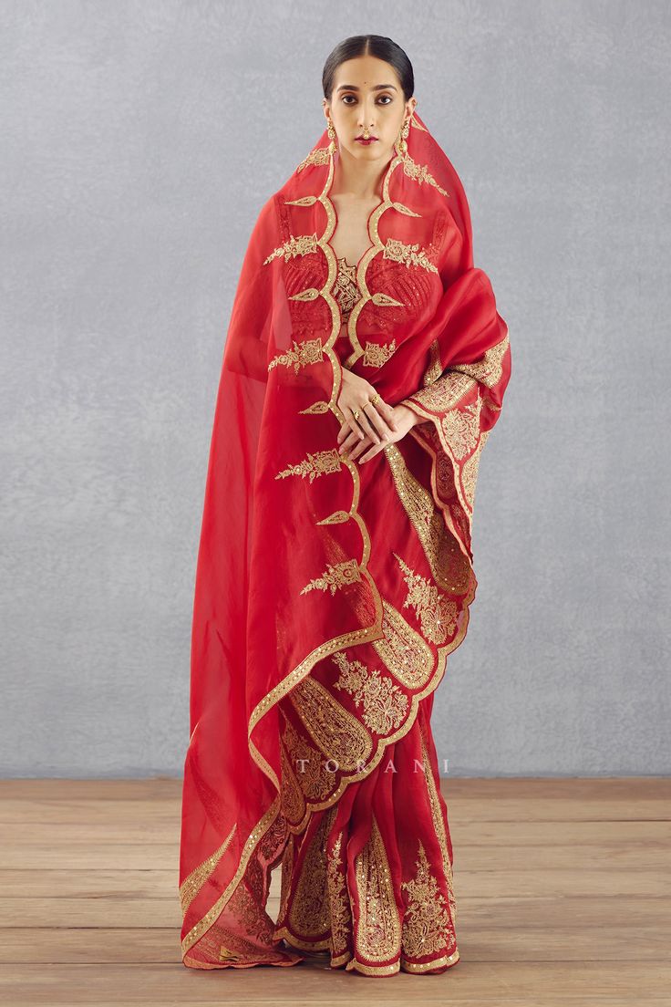 Bright red gota embroidered saree with scallop border in silk organza.
Component: 1
Pattern: Embroidered
Type Of Work: Dori, Adda
Fabric: Silk Organza
Color: Red
Other Details: 
Note: Blouse worn by the model is not for sale
Occasion: Bride,Wedding - Aza Fashions Saree Red, Saree Women, Scallop Border, Saree For Women, Embroidered Saree, Red Saree, Luxury Sale, Silk Organza, Red Silk