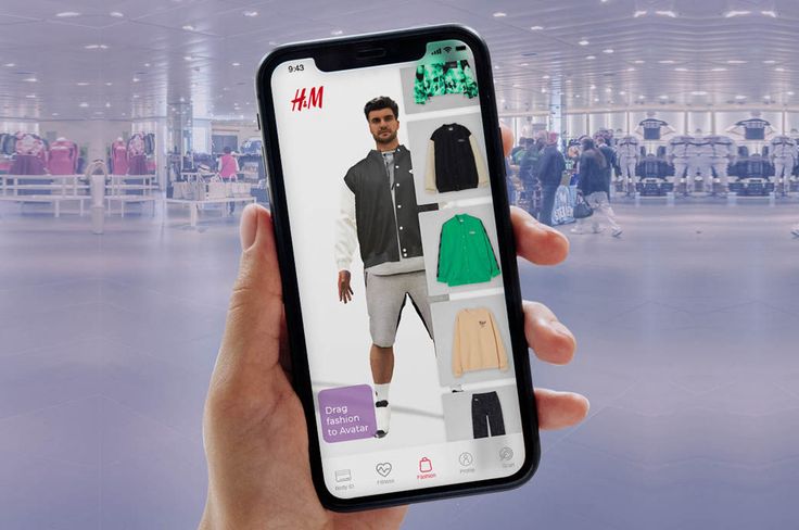 a person holding up an iphone with clothing on display in front of the phone screen