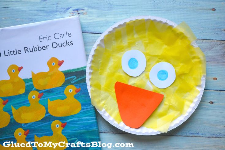 a paper plate with a yellow duck on it next to a children's book