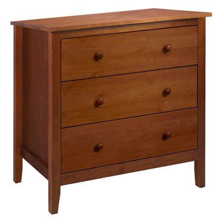 a wooden dresser with three drawers on it