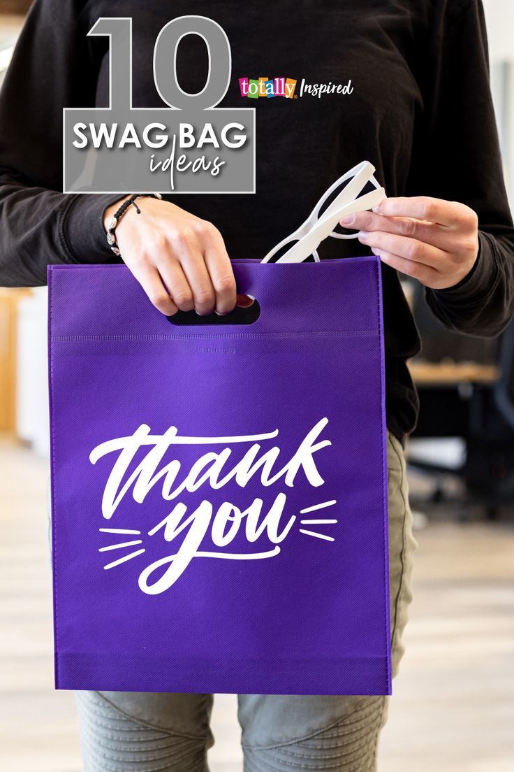 a person holding a purple bag with the words thank you on it