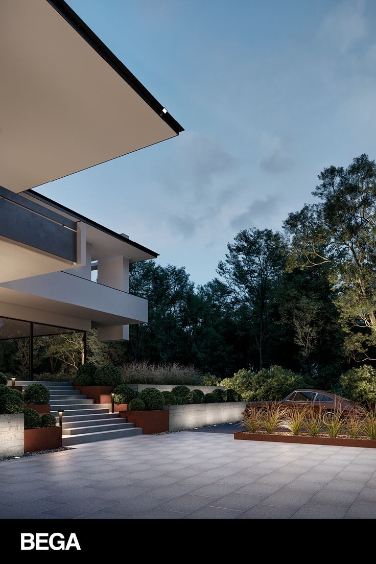 an outdoor area with plants and stairs leading up to the building's upper level