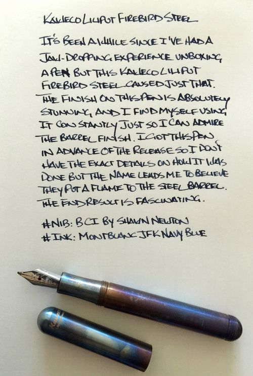 two fountain pens sitting next to each other on top of a piece of paper with writing