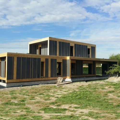 a large house sitting on top of a lush green field