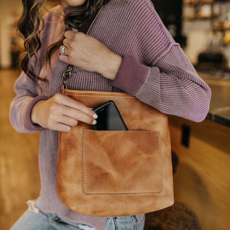 The ultra versatile Kennedy Crossbody bag is going to be your new go-to favorite. The Kennedy comes with a fully adjustable cross body strap as well as a short shoulder strap, giving you the ability to choose how to carry. Made of full grain, Horween leather, this bag features a zippered closure and both interior and exterior pockets. Thoughtfully designed and intentionally crafted, the Kennedy fits all styles with a rustic, yet refined look and feel. Crossbody Saddle Bag With Cell Phone Pocket For On-the-go, Versatile Soft Leather Saddle Bag For Daily Use, Leather Crossbody Bucket Bag For On-the-go, Versatile Soft Leather Crossbody Saddle Bag, Versatile Leather Crossbody Shoulder Bag, Crossbody Hobo Bag With Cell Phone Pocket For On-the-go, Everyday Crossbody Satchel, Everyday Top Handle Saddle Bag In Soft Leather, Leather Hobo Bag With Removable Pouch Crossbody