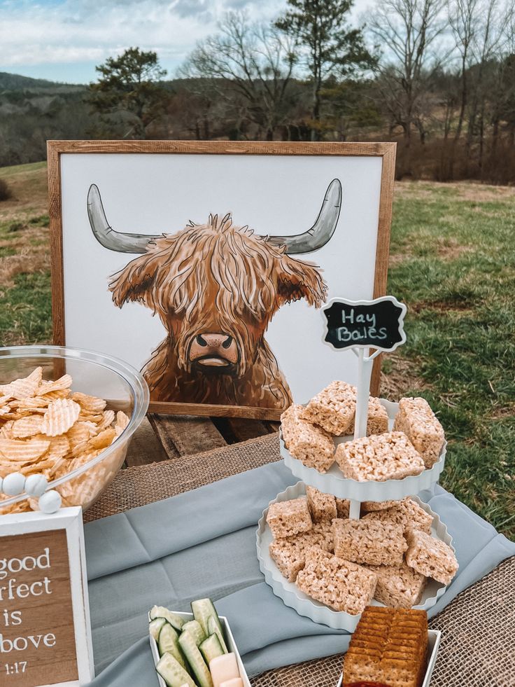 a table topped with lots of food next to a sign