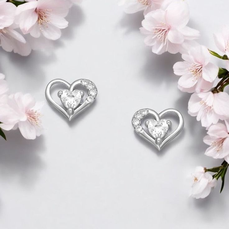 Elevate your style with our 925 Sterling Silver Heart Earrings featuring dazzling CZ diamonds. A blend of timeless charm and modern elegance! Width: 5⁄16 inches Height: 9⁄32 inches Double Heart Sparkling Stones Jewelry For Anniversary, Double Heart Jewelry With Sparkling Stones For Anniversary, White Cubic Zirconia Heart Earrings In Fine Jewelry Style, White Cubic Zirconia Heart Earrings, Fine Jewelry, White Cubic Zirconia Heart Earrings, Elegant Silver Heart Earrings For Pierced Ears, Elegant Heart Pendant Earrings For Anniversary, Elegant Double Heart Earrings For Valentine's Day, Elegant Double Heart Earrings For Anniversary