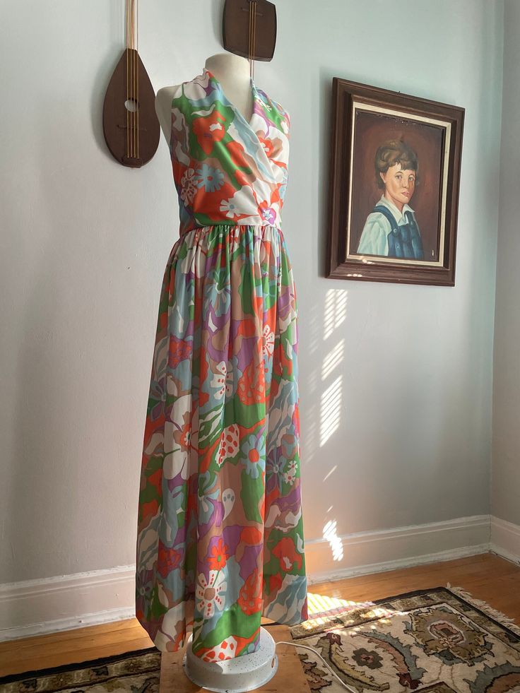 60s/70s Floral Halter Maxi Dress The print on this one is absolutely incredible. It is a floral polyknit that perfectly captures the late 60s and early 70s. The dress has an invisible, metal side zipper (one of the earliest invisible zipper models). The bodice is lined in a cotton for additional support. The skirt is gathered at the waist.  Returns are accepted up to 6 days after delivery. Customer is responsible for return postage and a 25% restocking fee. Tracking information must be provided within the 6 days. The refund will be issued upon the items return in its original condition. There are NO exceptions to this policy. By completing this transaction, you are agreeing to this policy. - - Measurements: Bust- Up to 36" Waist- 28" Hips- Open Retro Multicolor Maxi Dress For Spring, Spring Mod Dress With Vintage Print, Mid-century Floral Print Dress For Spring, Mid-century Floral Print Spring Dress, Retro Multicolor Maxi Dress For Garden Party, 1970s Retro Print Spring Dress, Retro Spring Maxi Dress With Vibrant Print, 1970s Style Multicolor Maxi Dress, 1970s Style Vintage Print Spring Dress