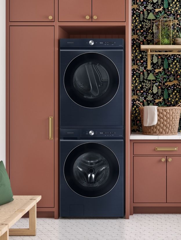 the front load washer and dryer are next to each other in this laundry room