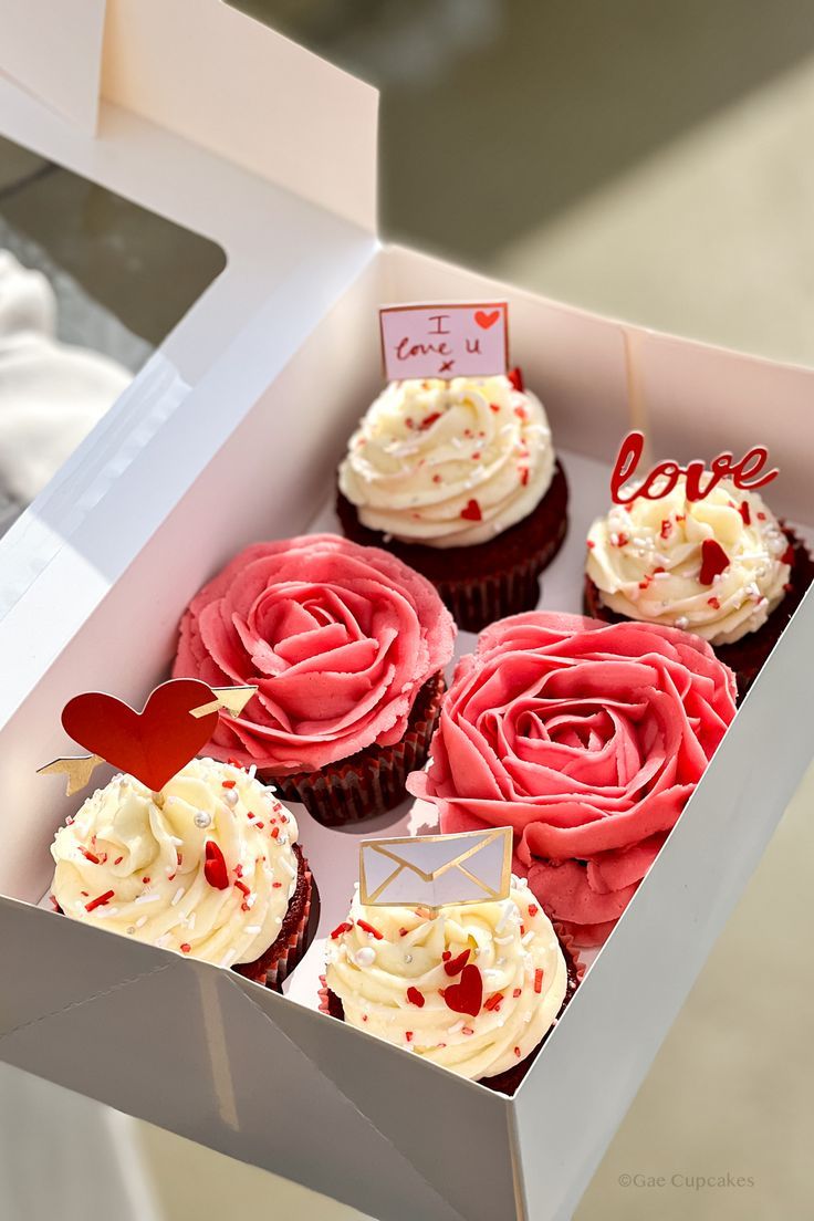 the cupcakes are decorated with red and white frosting