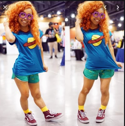 a woman with red hair wearing glasses and shorts