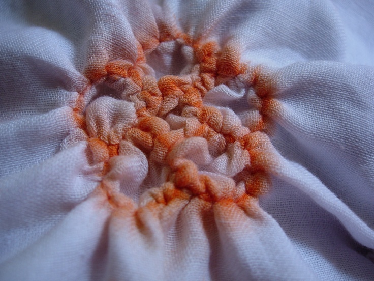 an orange and white flower is shown in this close up photo, with the center section visible