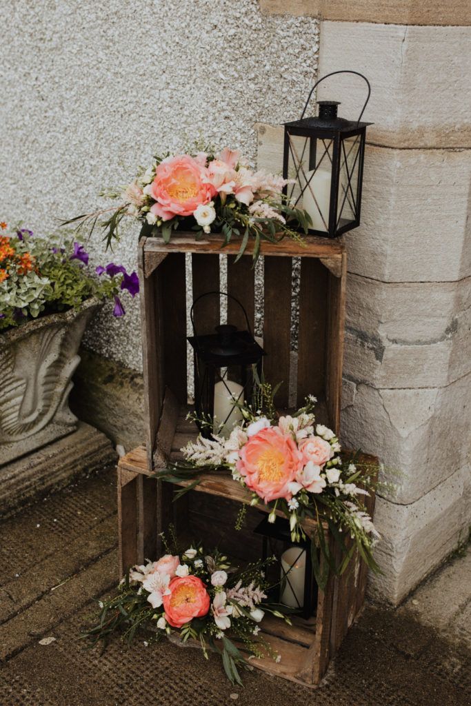 two wooden crates with flowers and lanterns on them