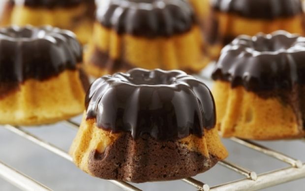 chocolate covered bundt cakes cooling on a rack