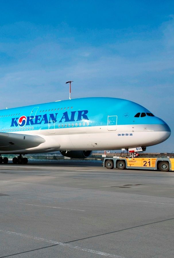 a korean air plane on the tarmac at an airport