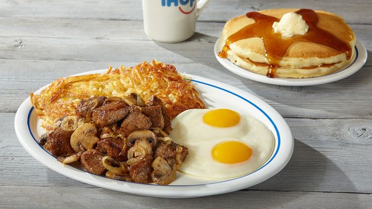 two breakfast plates with eggs, pancakes and hash browns on them next to a cup of coffee