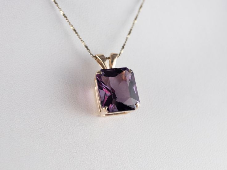 This amethyst gem is bursting with brilliant purple color! The emerald-cut faceting optimizes its luster, and the yellow gold only compliments the stone with its warm hue. This pendant could be worn every day or for special occasions! This pendant does not come with the chain shown. Please feel free to contact us, we will help you find the perfect chain for your style and budget!Metal: 14K Yellow GoldGem: Amethyst 8.48 CaratsGem Measurements: 14.2 x 12.2 mm, Emerald Cut Measurements: 22 x 12 mm, with bail Elegant Purple Necklace, Purple Radiant Cut Jewelry For Anniversary, Elegant Emerald Cut Purple Jewelry, Elegant Purple Emerald Cut Jewelry, Purple Emerald Cut Birthstone Jewelry, Purple Rectangular Jewelry With Prong Setting, Fine Jewelry With Rectangular Purple Stone, Emerald Cut Amethyst Jewelry With Center Stone, Classic Purple Jewelry With Rectangular Stone