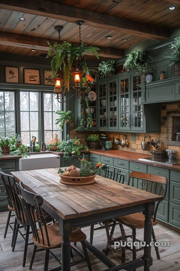 a kitchen with green cabinets and wooden table surrounded by chairs, potted plants on the counter