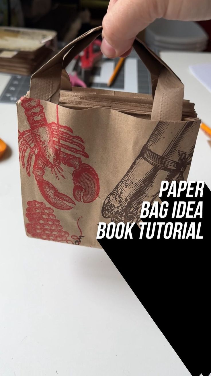 a hand holding a paper bag with an image of a motorcycle on it and the words paper bag idea book tutor written below