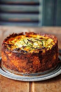 a quiche is sitting on top of a wooden table