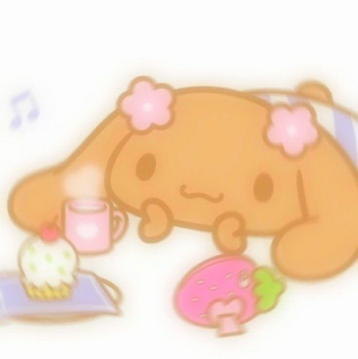 a brown teddy bear sitting on top of a table next to a cupcake and donut