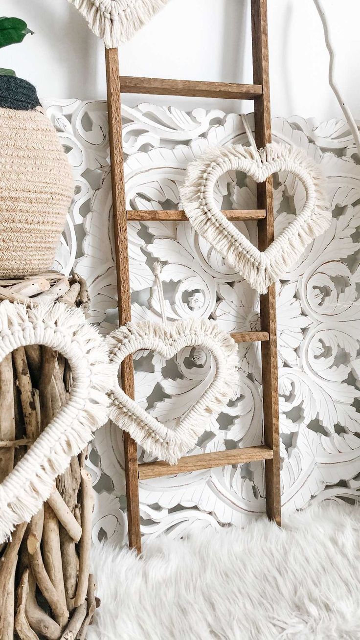 a wooden ladder sitting next to a basket filled with hearts on top of a white rug