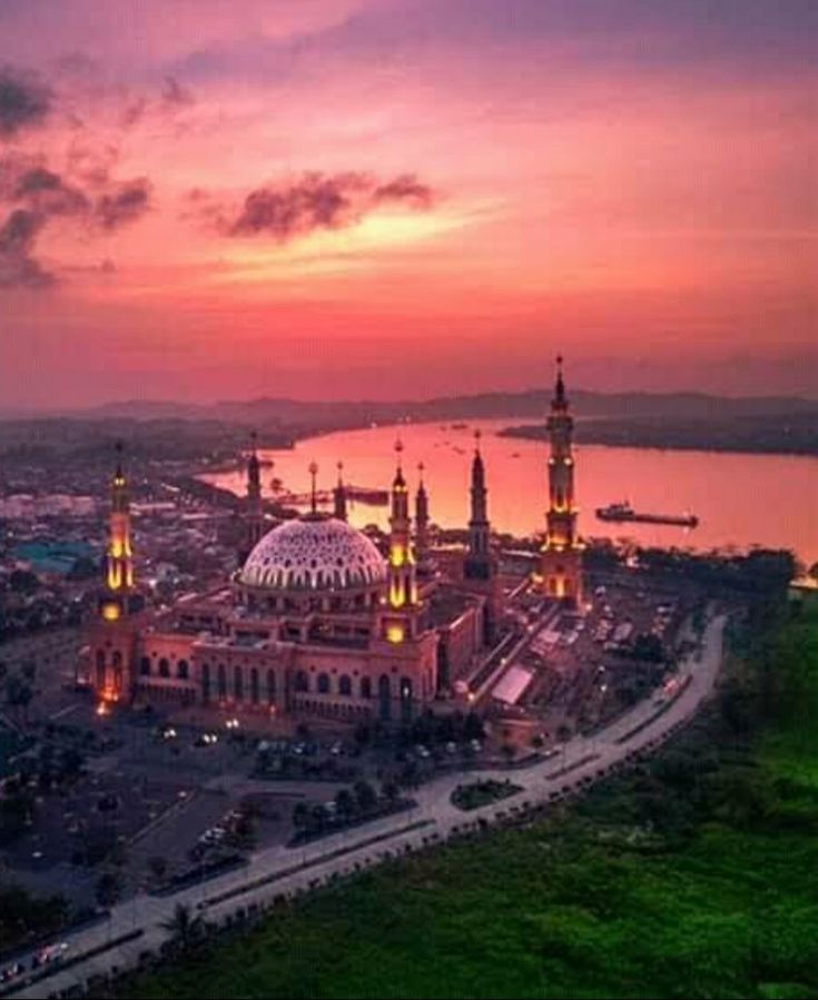 an aerial view of a large building at sunset